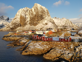 Cabins overlooking water and mountains
